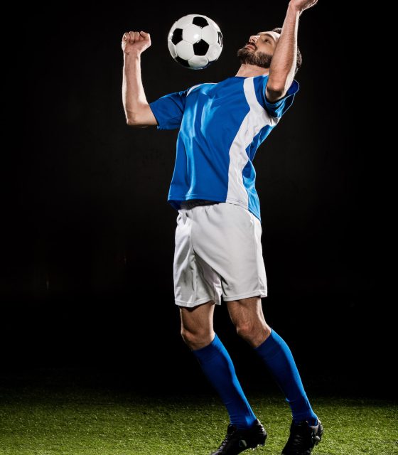 handsome-football-player-in-uniform-jumping-with-b-2021-10-07-21-28-36-utc.jpg